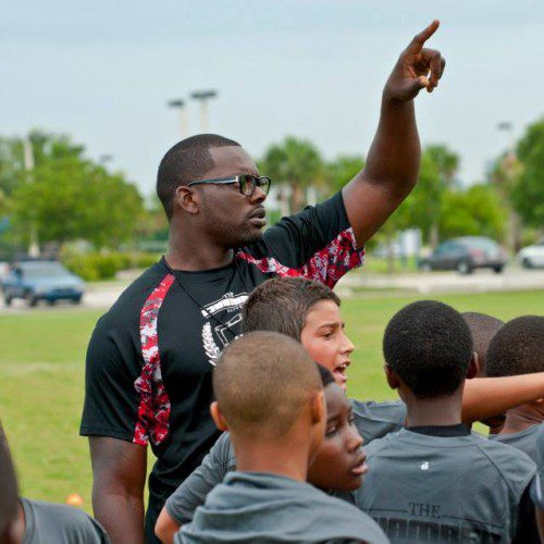 A person leading a group of kids