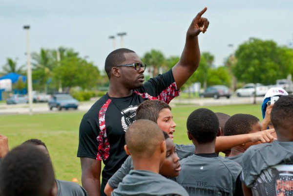 A person leading a group of kids